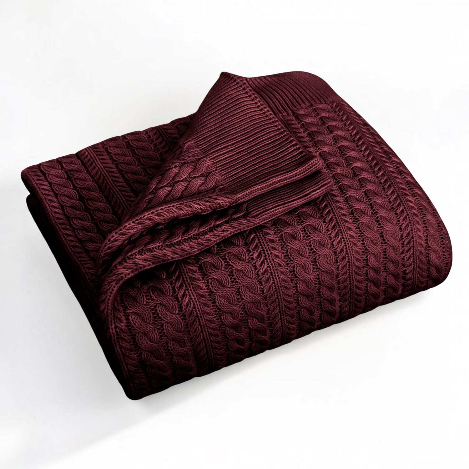 A folded burgundy-colored cable-knit blanket with a ribbed border, displayed on a clean white background.