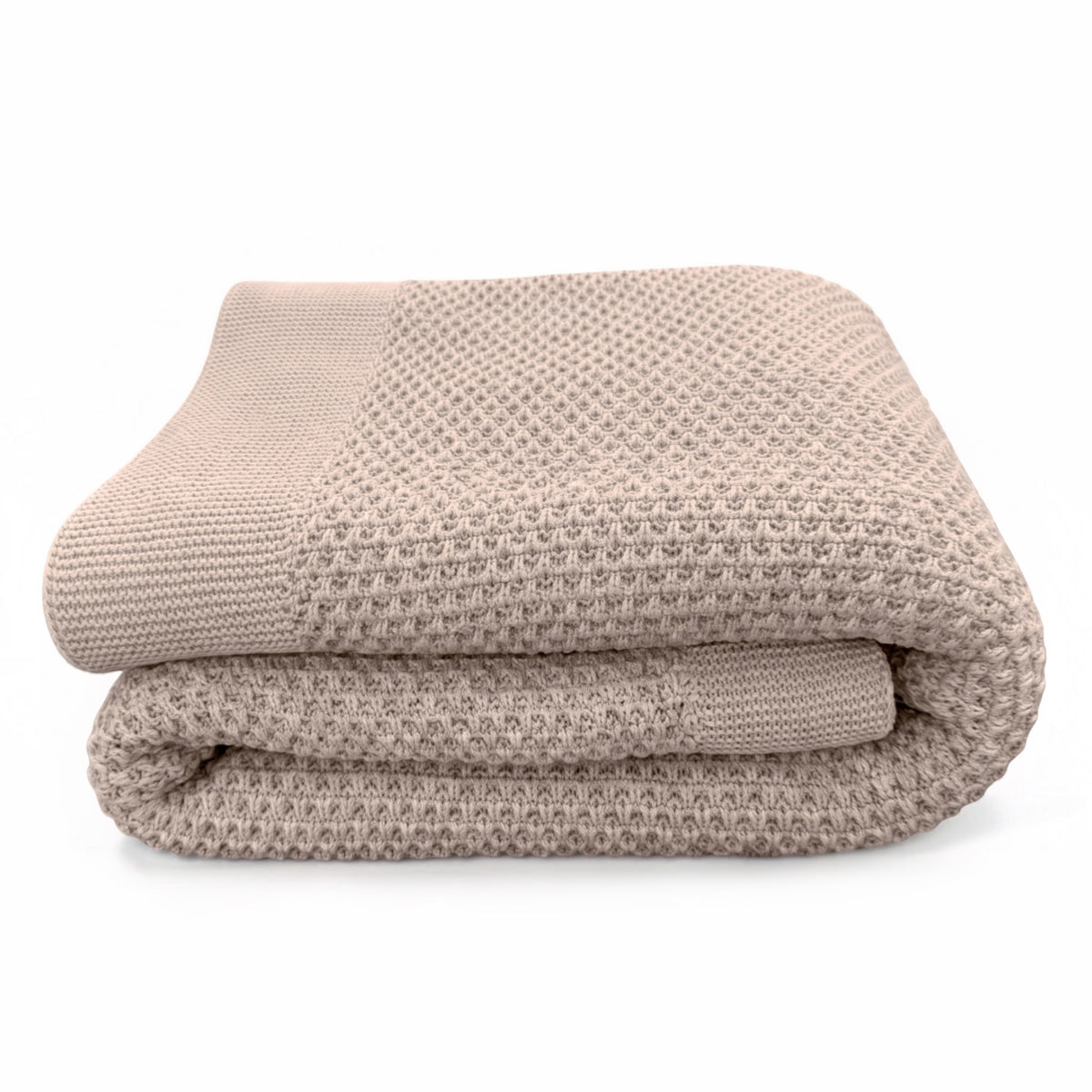 A folded honeycomb weave knit blanket in a warm taupe-beige color with a ribbed knit border, set against a plain white background.