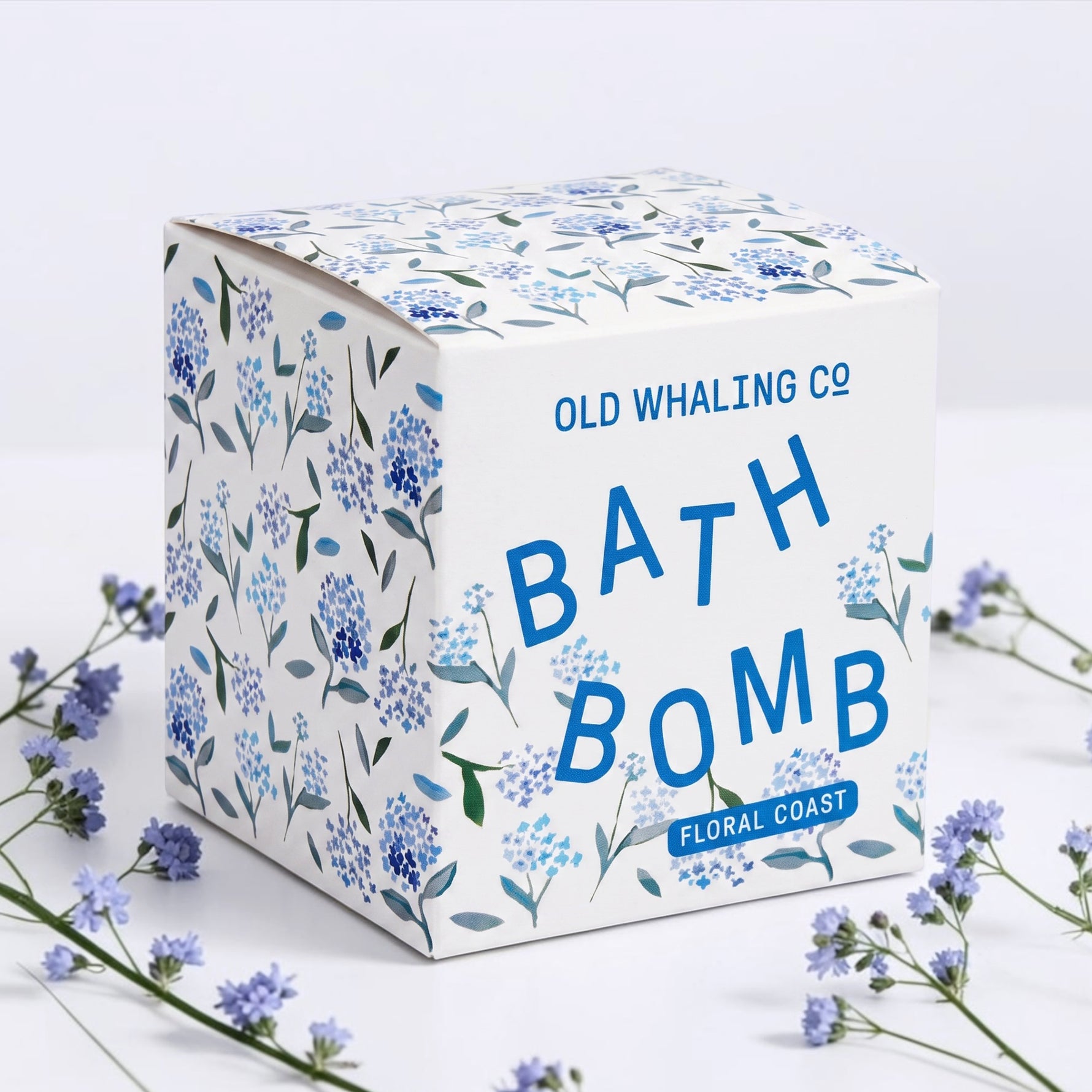 Old Whaling Co Bath Bomb in Floral Coast scent, styled with small flowers on a white background.