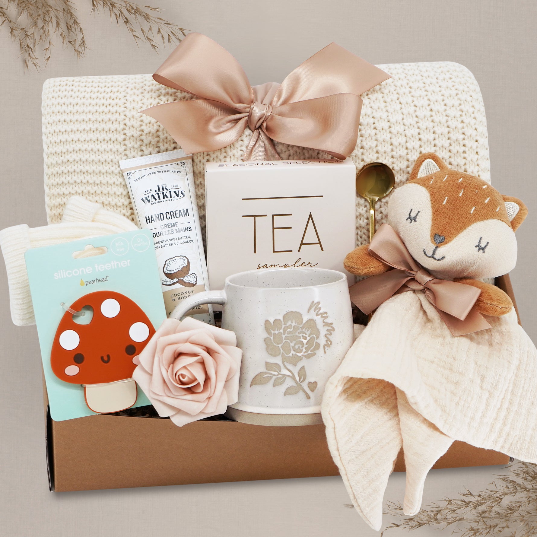 Wildflower Pop Forest Friends New Baby and New Mama Blanket Gift Box comes with a cream lace knit blanket tied with a nude bow, JR Watkins lotion, Pearhead Mushroom silicone teether, faux rose, Wildflower Pop ceramic mama mug, Tea Sampler, Fox movie and gold demiatsse spoon