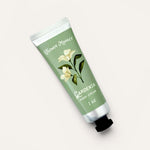 Hand cream tube labeled 'Gardenia' from 'Flower Market' on a light background