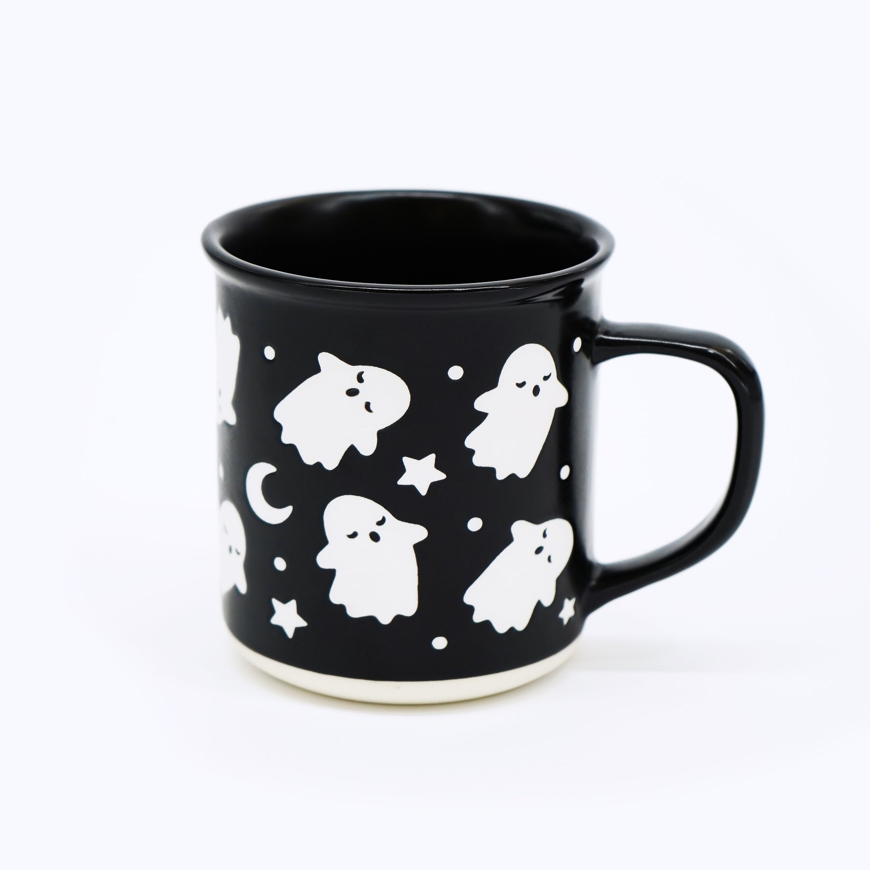 Exclusive to Wildflower Pop Black mug with white ghost and star pattern on a white background