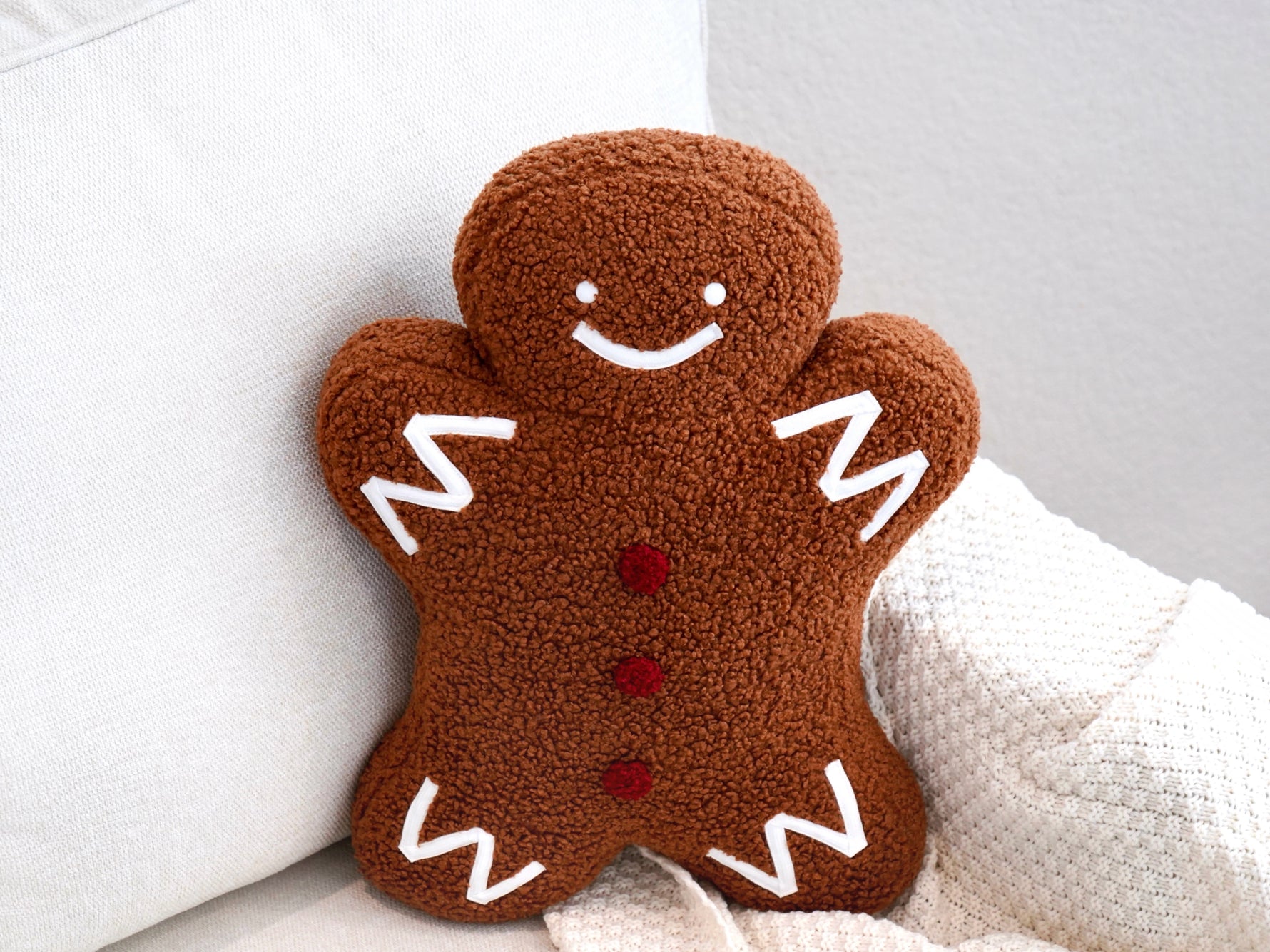 Plush sherpa gingerbread pillow measures 18"x14"