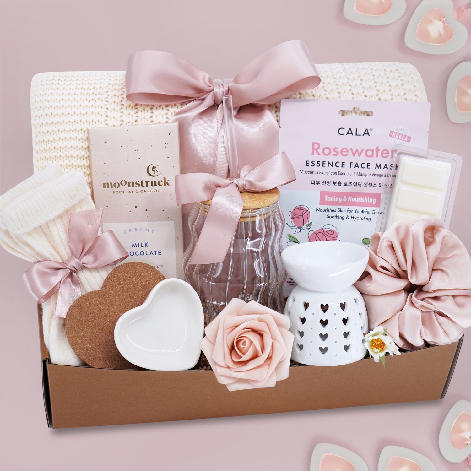 Wildflower Pop Hearts to You Valentine's  Day Gift Box with a cream lace knit blanket, Rosewater face mask, moon struck milk chocolate bar, cream knit socks, heart coaster and trinket dish, wavy glass tumbler, heart wax warmer, wax melt, and blush scrunchie 