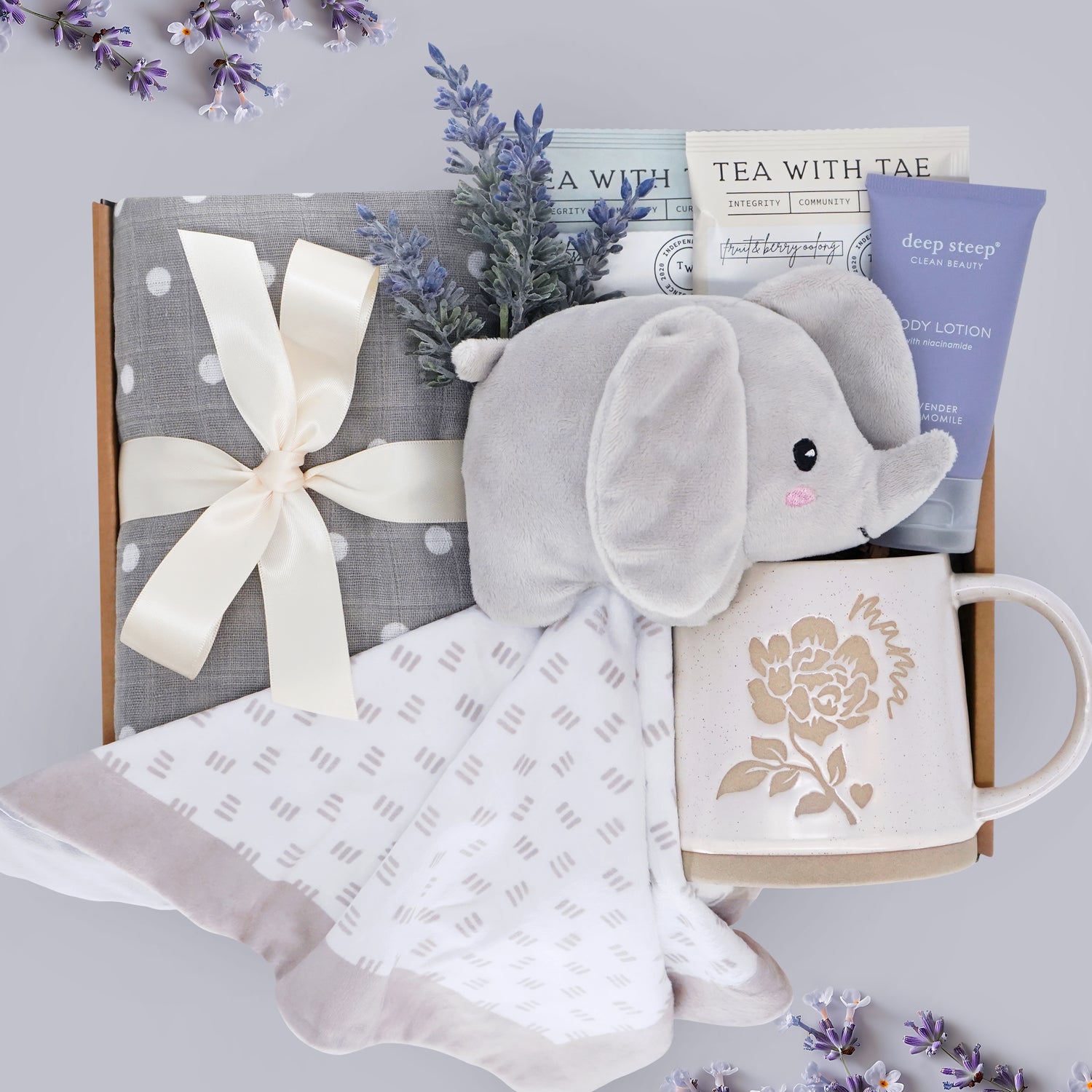 Hello Cutie Wildflower Pop New Baby and New Mama gift box comes with a grey polka dot cotton swaddle, Elephant love, tea sampler, deep steep lavender lotion, and Wildflower Pop ceramic mama mug