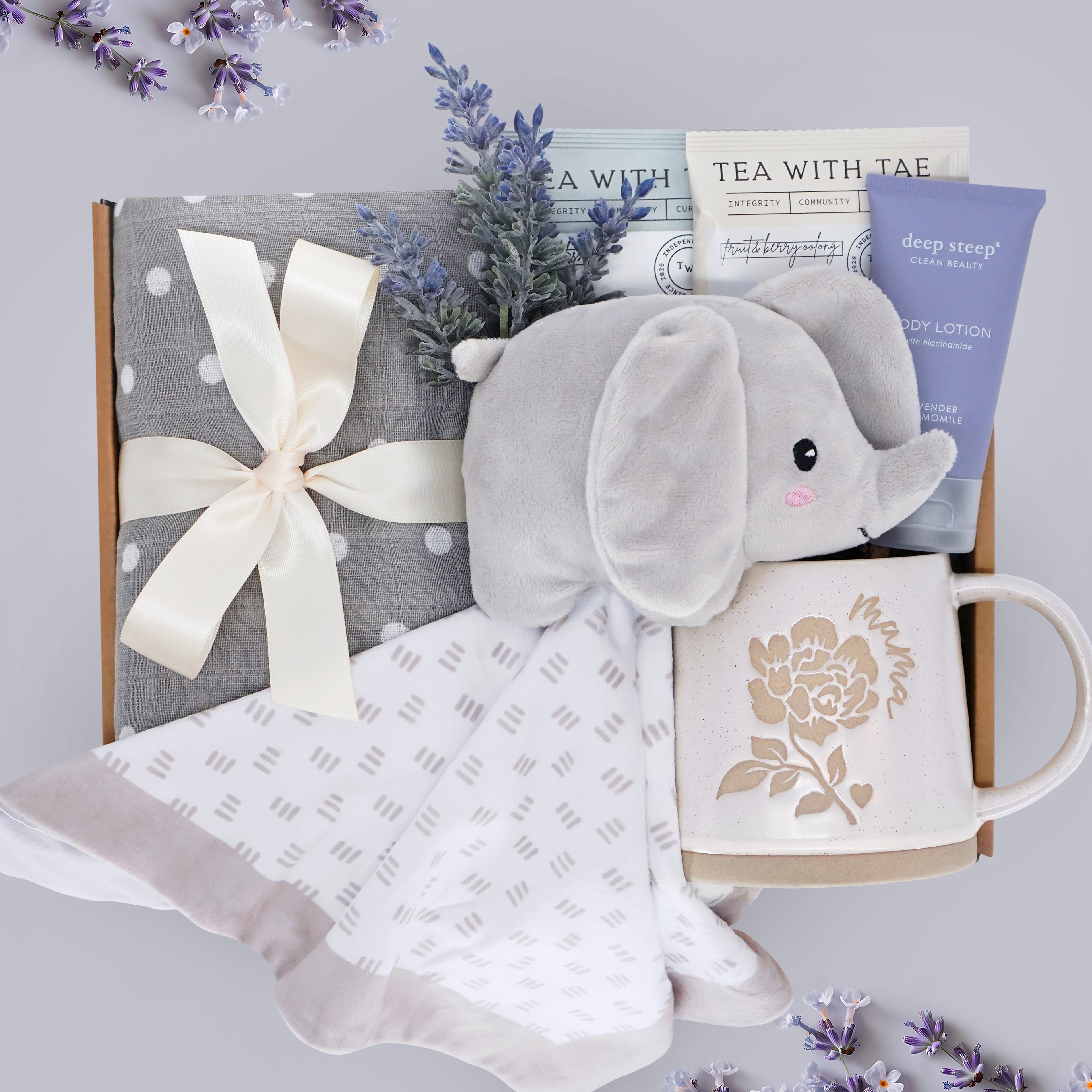 Hello Cutie Wildflower Pop New Baby and New Mama gift box comes with a grey polka dot cotton swaddle, Elephant love, tea sampler, deep steep lavender lotion, and Wildflower Pop ceramic mama mug