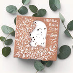 Herbal bath coin eucalyptus and tea scent on a white background with leaves