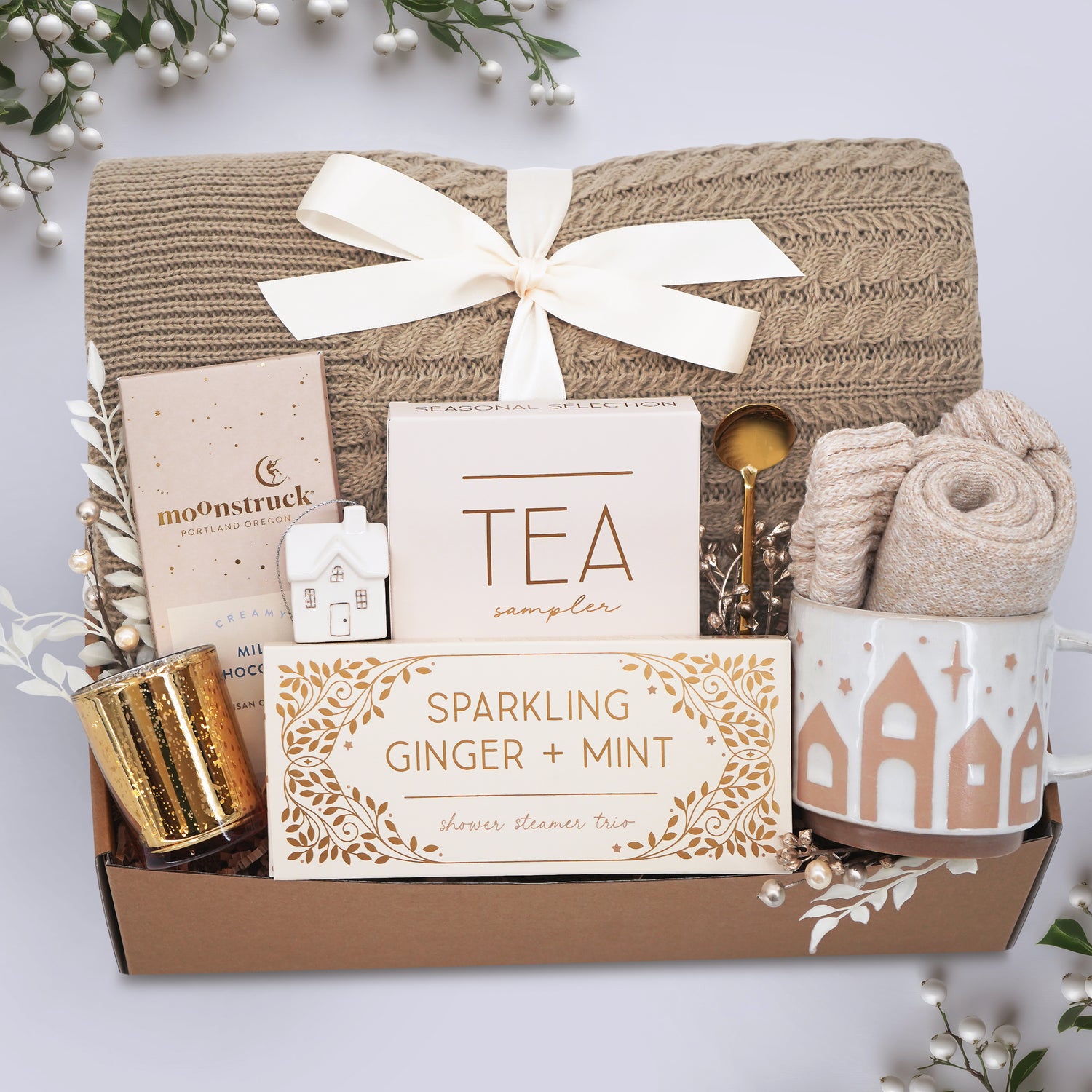 Wildflower Pop Gift basket with tea sampler, candle, and other items on a light background