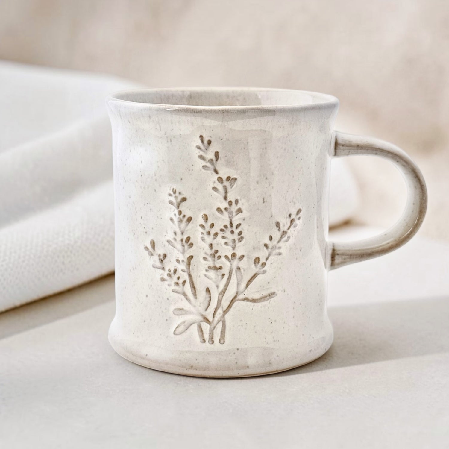 Ceramic mug with a rustic lavender design on a neutral background