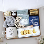 Light of the Moon mug box comes with moon and sun ceramic mug, cozy boot socks, mini honey and dipper, 2 tea bags, moon wood nordic ornament, old whaling co mariners moon bath bomb, votive and tea light 