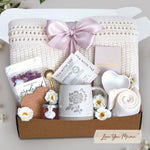 Love you mama blanket box comes with a cream lace knit blanket tied in a blush ribbon, 2 tea with tae tea bags, gold demitasse spoon, rose seaside soak bath salts, heart coaster, mini honey, mama ceramic mug, heart trinket dish, full size moonstruck milk chocolate bar, and cream knit socks