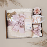 Wildflower Pop Cherry Blossom Gift box with tea, chocolate, mug, and decorative elements on a neutral background