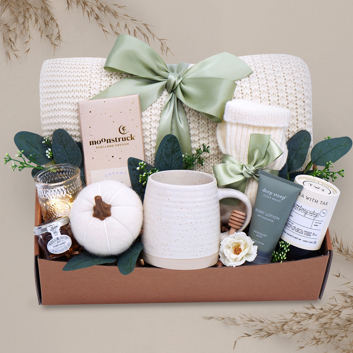 Farmers Market blanket gift box with a mug, candle, and other items on a gray background