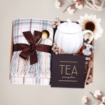 Scarf Weather gift set with cozy plaid scarf, pumpkin mug, tea sampler, and mini honey and dipper on a gray background