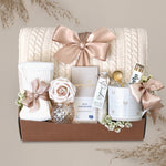 Wildflower Pop Sending Serenity Blanket Gift Box with cream cable knit blanket, moonstruck chocolate, cream knit socks, floral bath salts, Wildflower Pop ceramic heart mug, matches, votive and tea light 