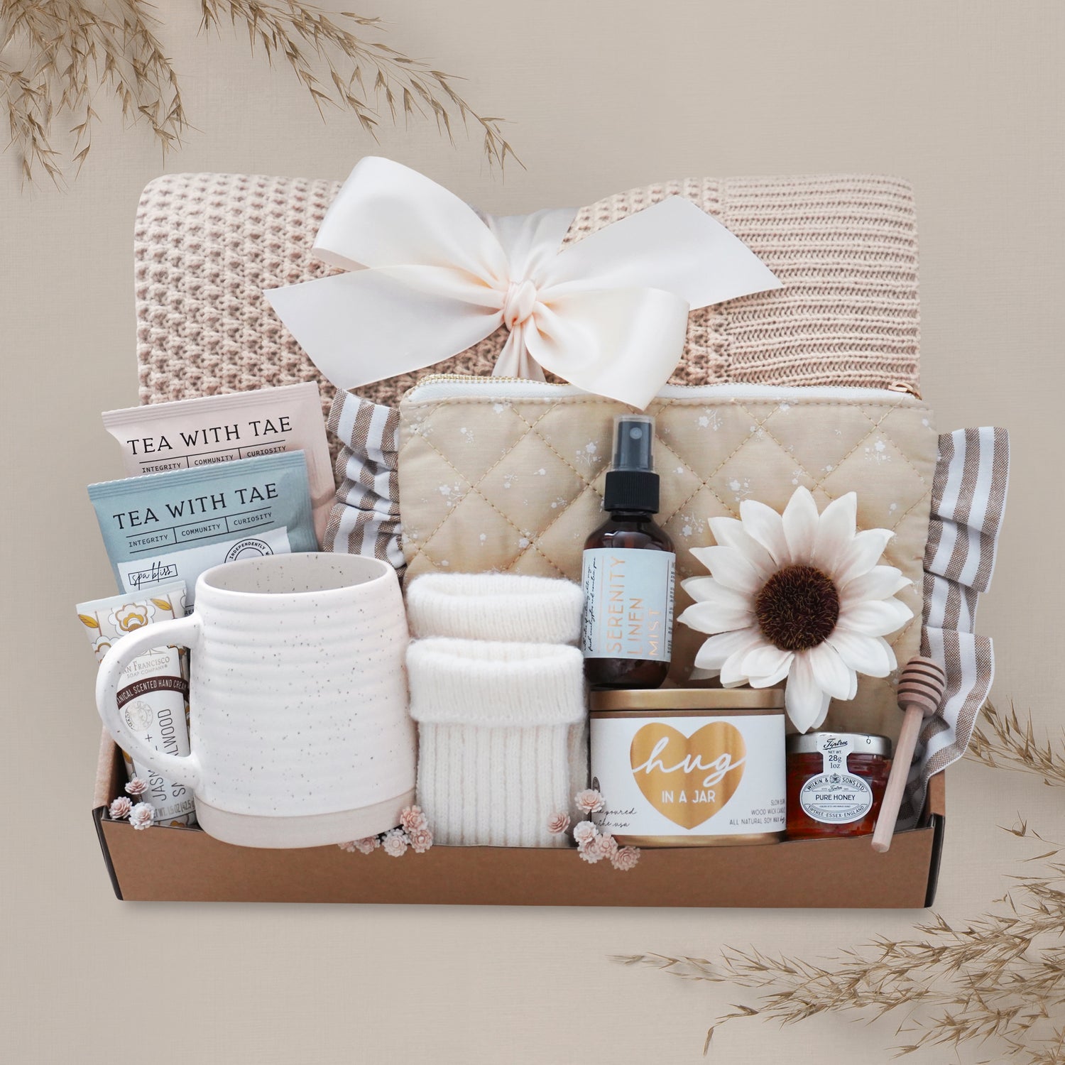 Sweet Honeybee luxury gift box featuring honeycomb knit blanket, candle, tea, mug, honey jar, socks, and self-care essentials for Mother’s Day