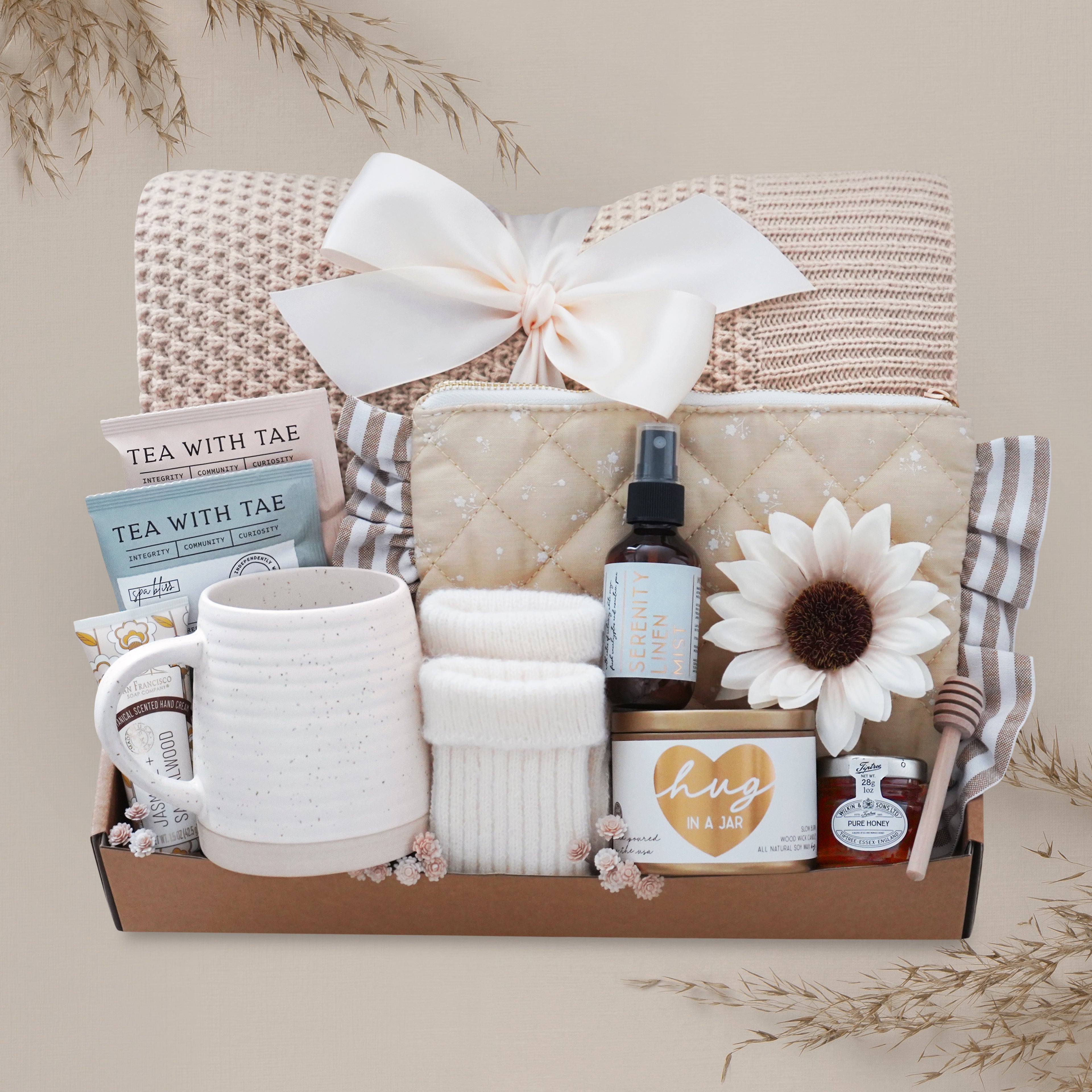Sweet Honeybee luxury gift box featuring honeycomb knit blanket, candle, tea, mug, honey jar, socks, and self-care essentials