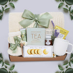 Wildflower Pop Tea Party for One comes with a cream lace knit blanket, cream knit socks, Flower Market Gardenia hand cream, Tea Sampler, Rustic Bakery shortbread cookies, ribbed white ceramic mug, mini honey and dipper