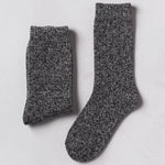 A pair of dark gray mens heathered knit crew socks laid flat on a light gray surface.