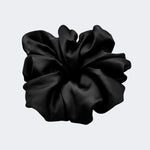 A single jumbo satin hair scrunchie in Midnight black centered on a light gray background.