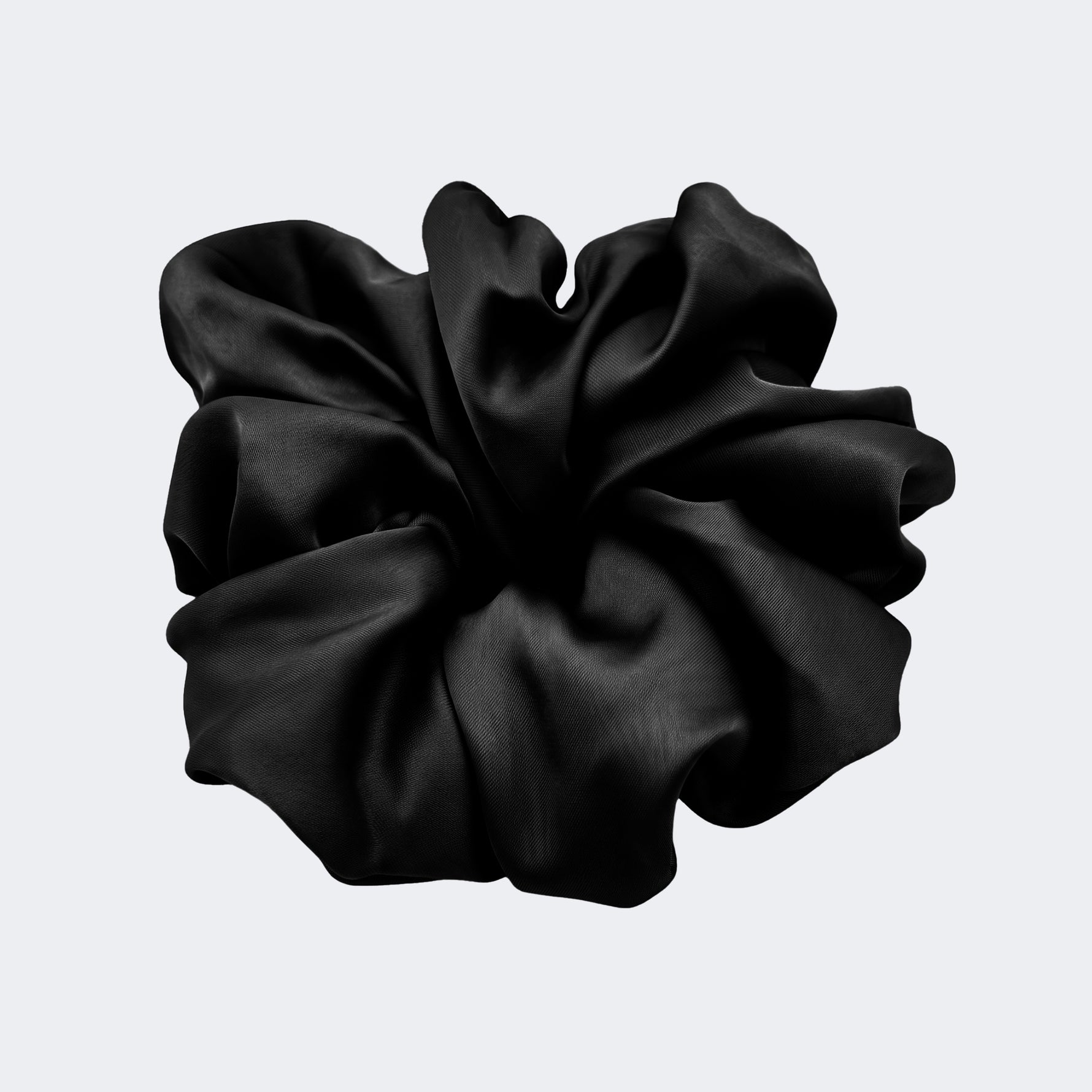 A single jumbo satin hair scrunchie in Midnight black centered on a light gray background.