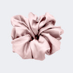 A single jumbo satin hair scrunchie in Milk Tea nude centered on a light gray background.