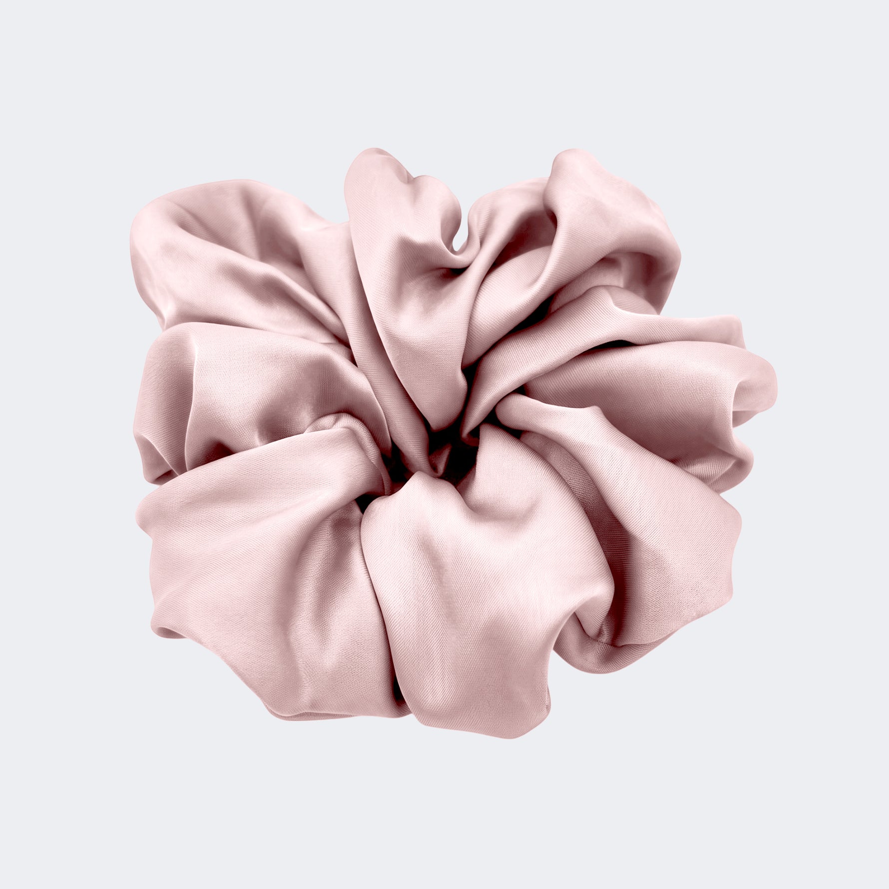 A single jumbo satin hair scrunchie in Milk Tea nude centered on a light gray background.