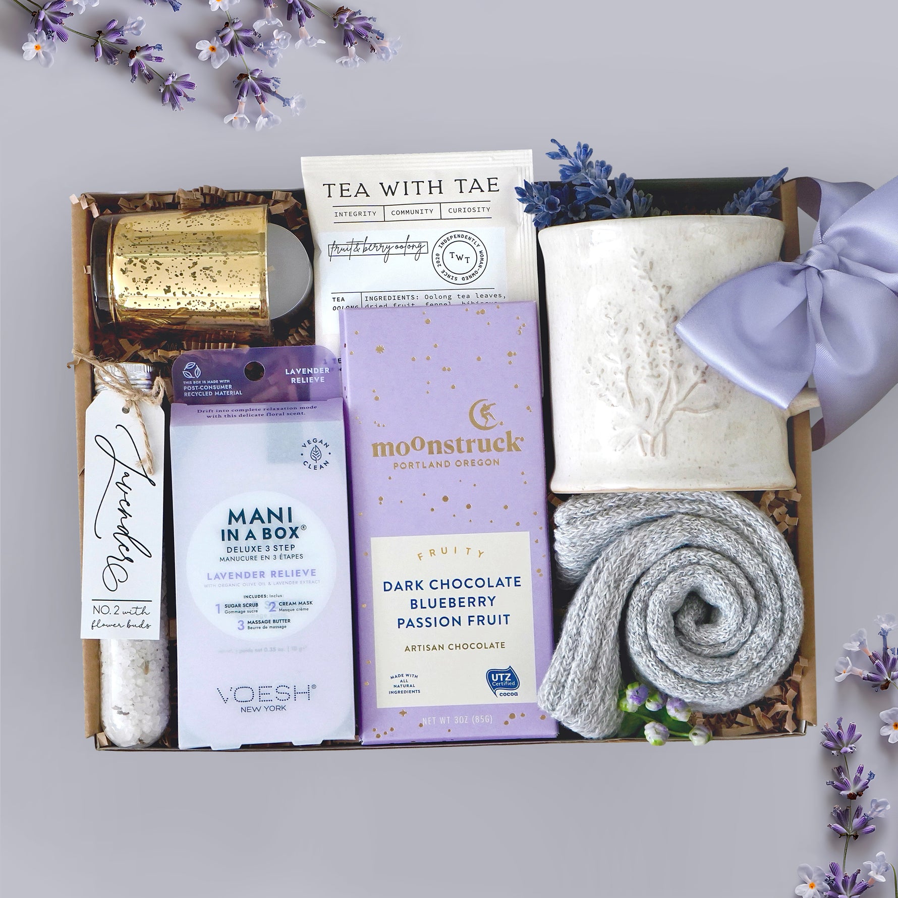 Wildflower Pop Mini Spa Day Mug Box with a ceramic lavender sprig mug, grey cozy boot socks, 2 tea bags, moonstruck dark chocolate, votive and tea light, mani in a box, and lavender bath salts 