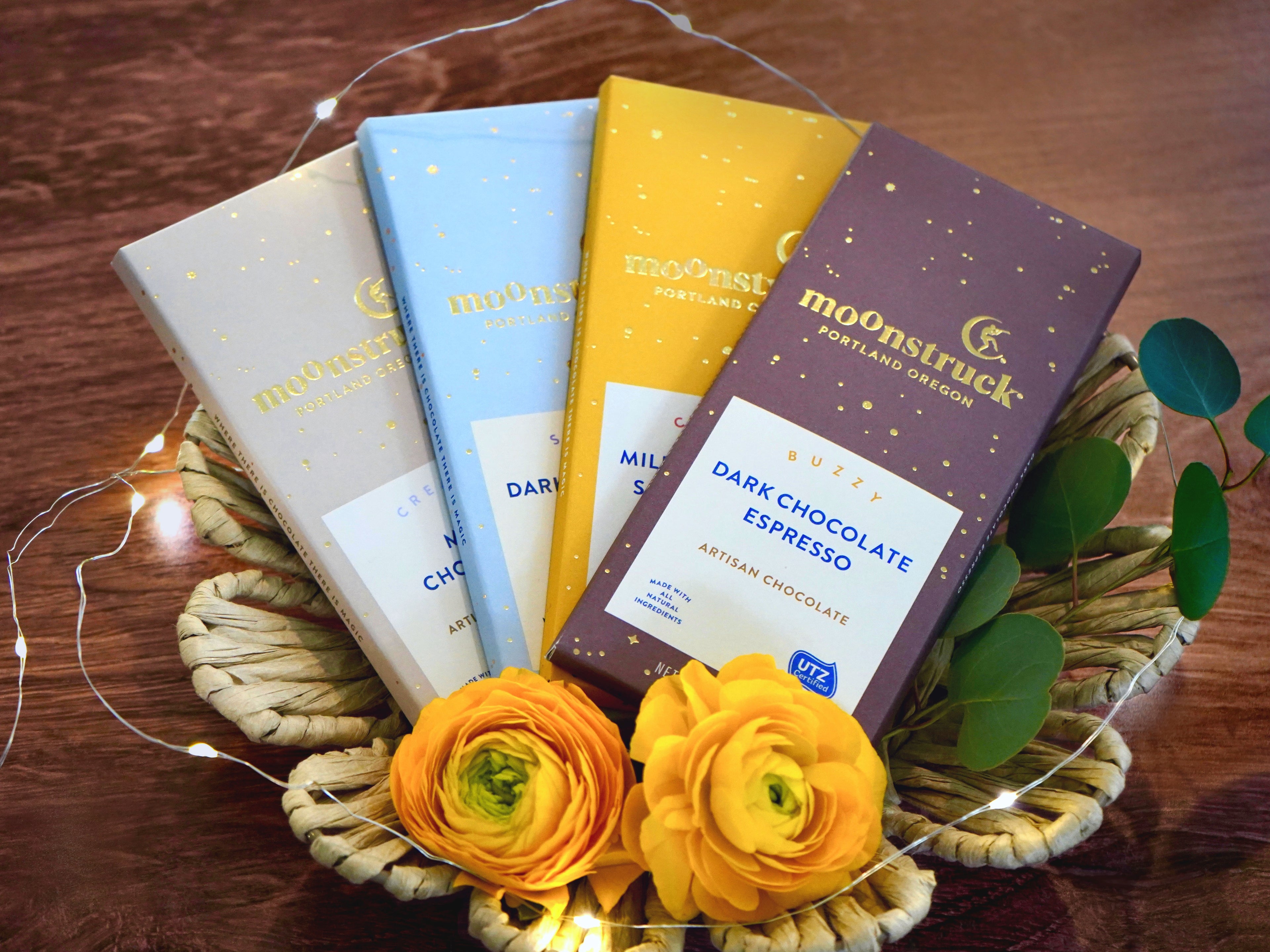 Moonstruck chocolate bars shown in milk chocolate, dark chocolate almond, milk chocolate toffee, and dark chocolate espresso