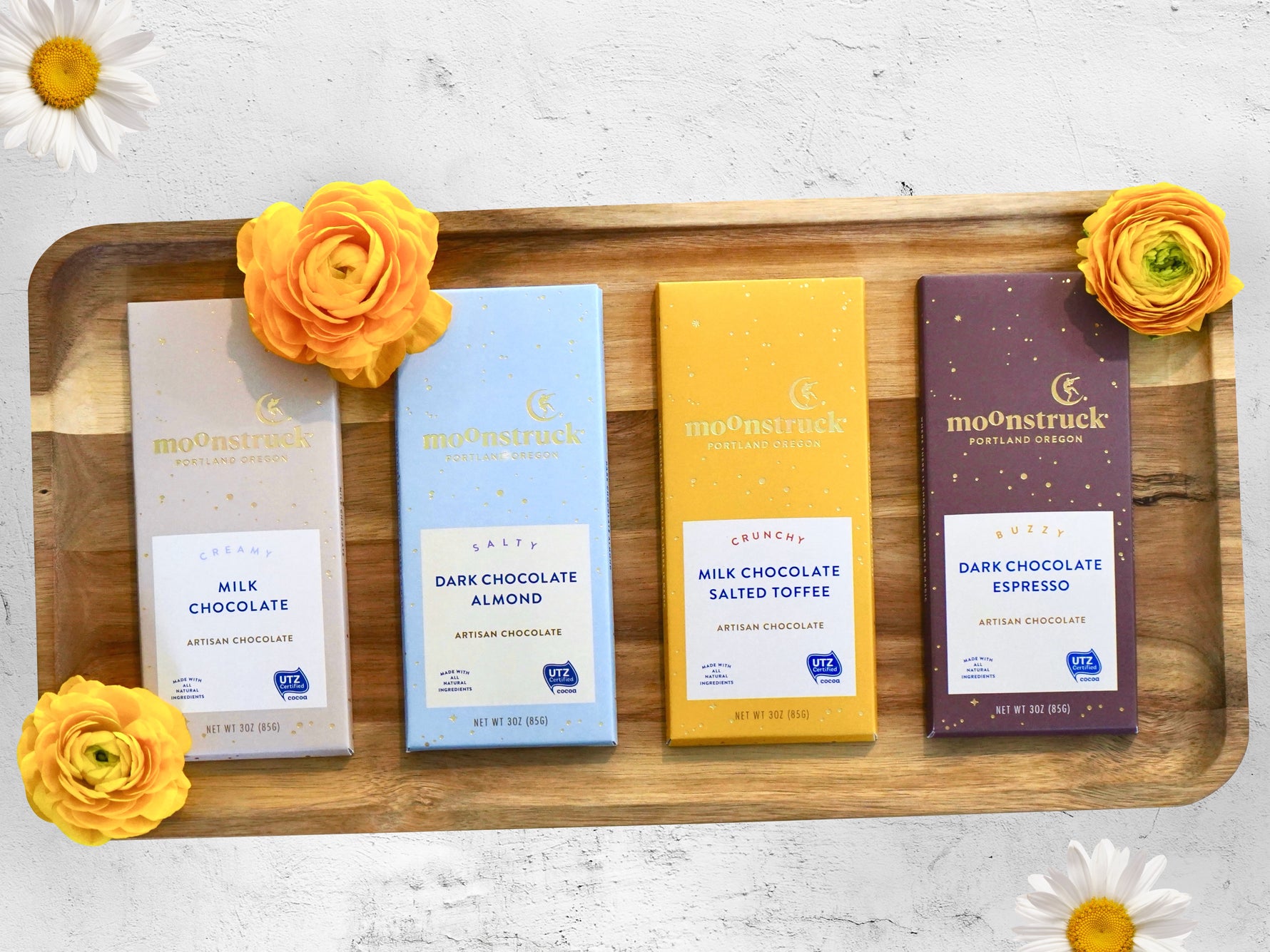 Moonstruck chocolate shown in milk chocolate, dark chocolate almond, milk chocolate salted toffee, and dark chocolate espresso 