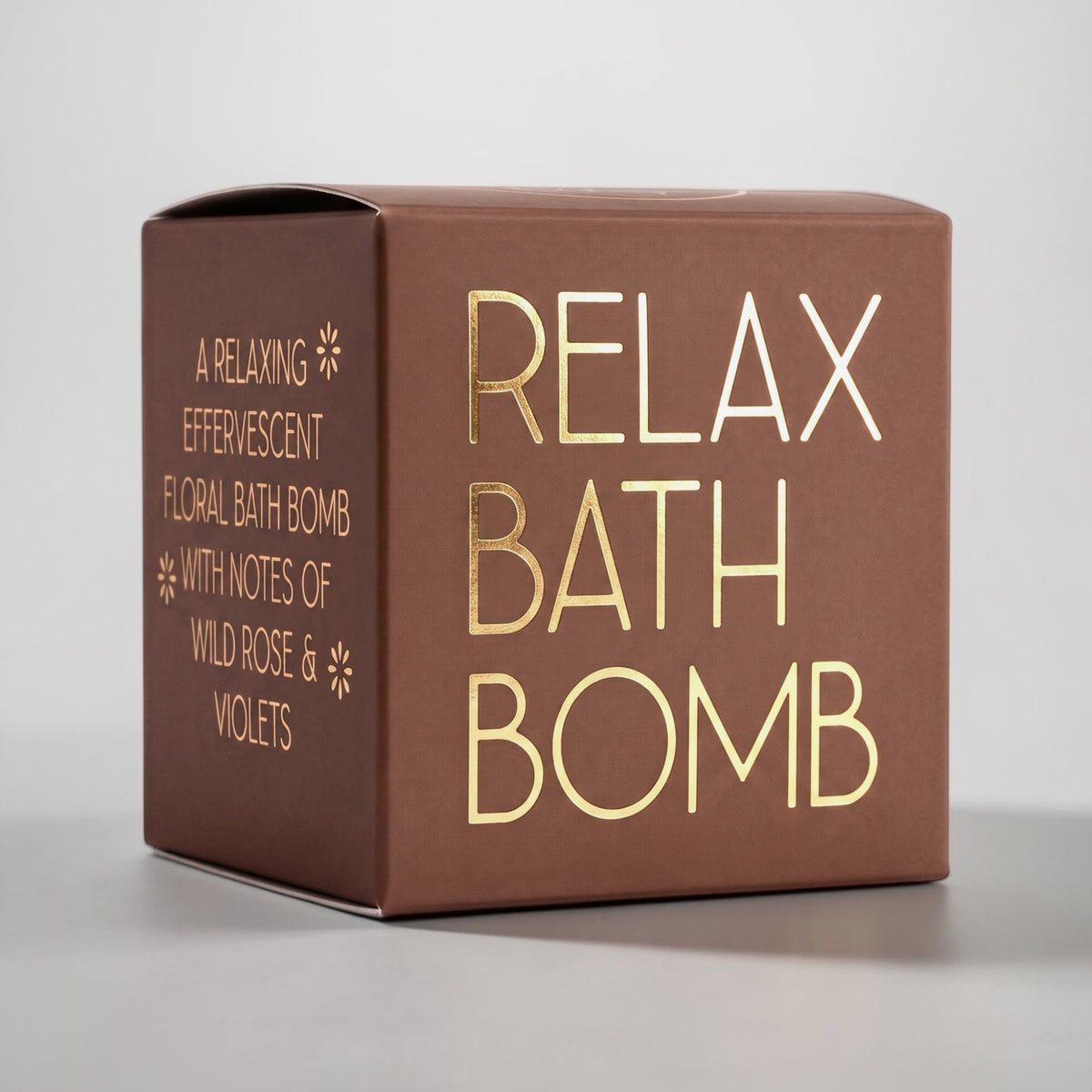 Wildflower Pop Relax Bath Bomb in a terracotta box with gold foil, a relaxing scent with notes of wild rose and violets.