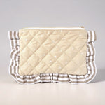 Quilted pouch with ruffled edge on a light gray background