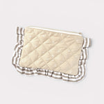 Quilted pouch with striped border on a light gray background