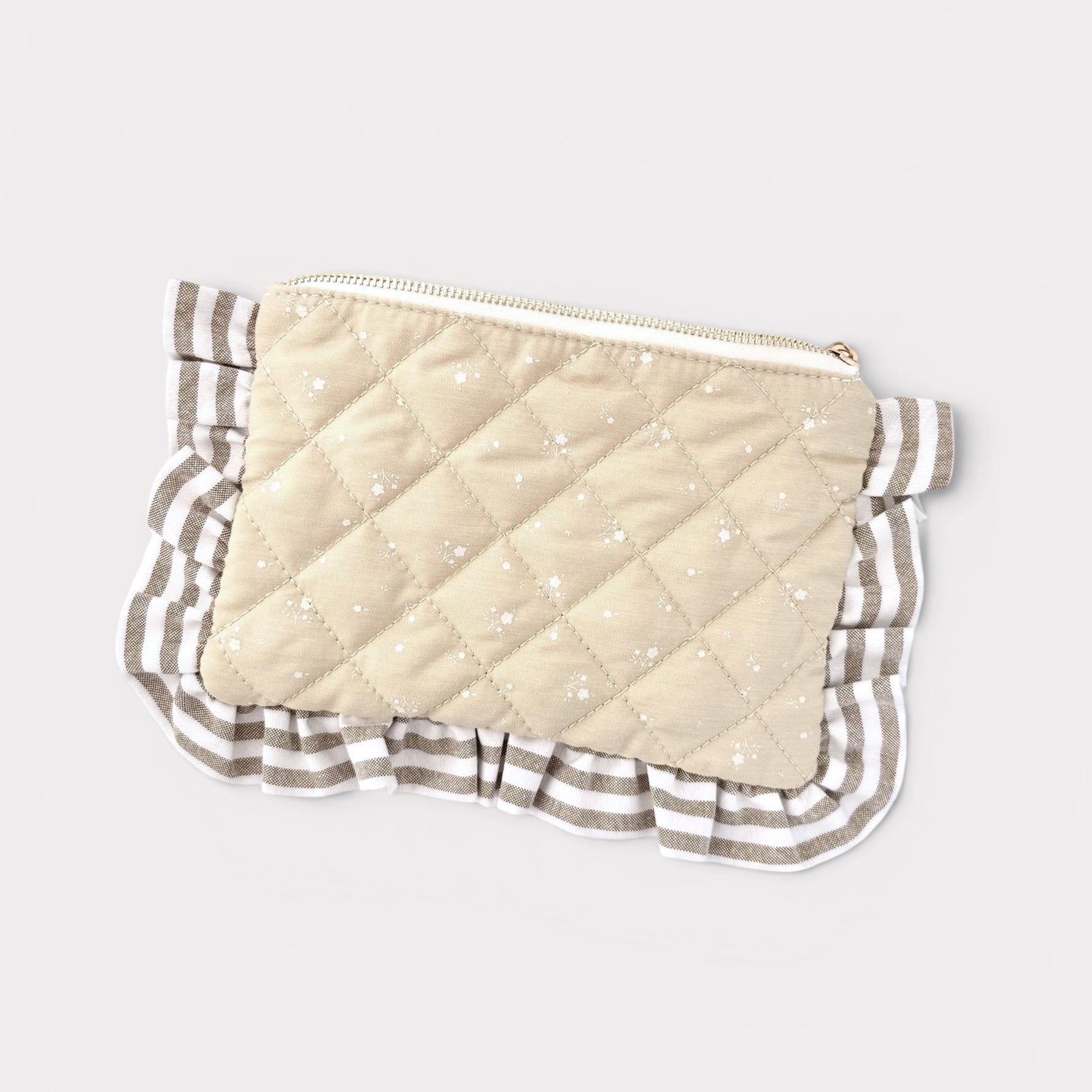 Quilted pouch with striped border on a light gray background