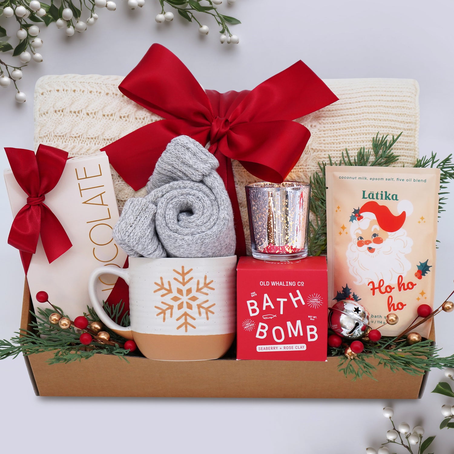 Wildflower Pop Gift basket with holiday-themed items including a mug, bath bomb, and bath salts on a white background.