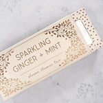 Box of Sparkling Ginger + Mint shower steamers on a gray surface.