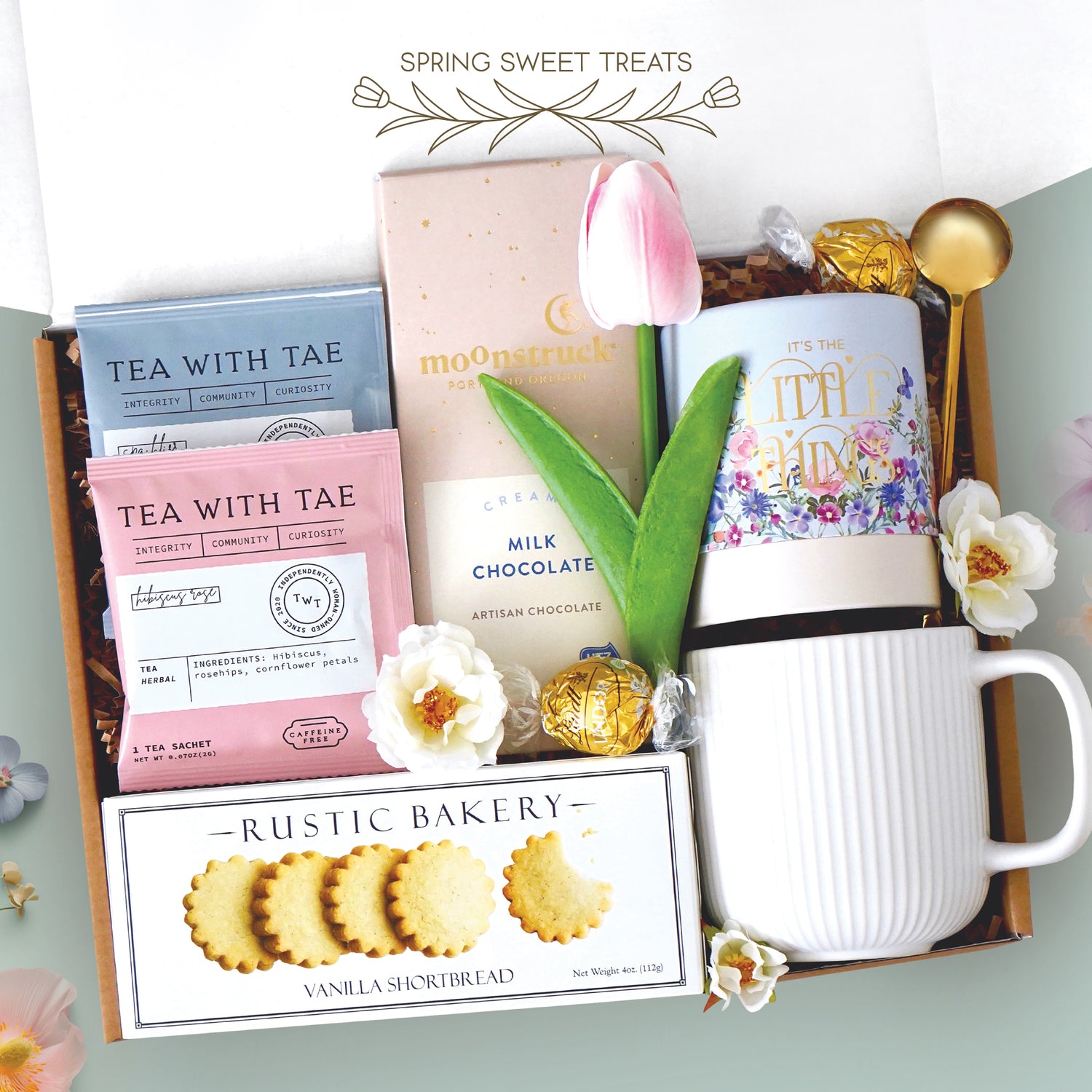 Spring sweet treats mug box come with a ribbed white ceramic mug, it's the little things tube with lindt truffles, gold demitasse spoon, full size milk chocolate moonstruck bar, 2 tea with tae tea bags, and rustic bakery vanilla shortbread cookies 