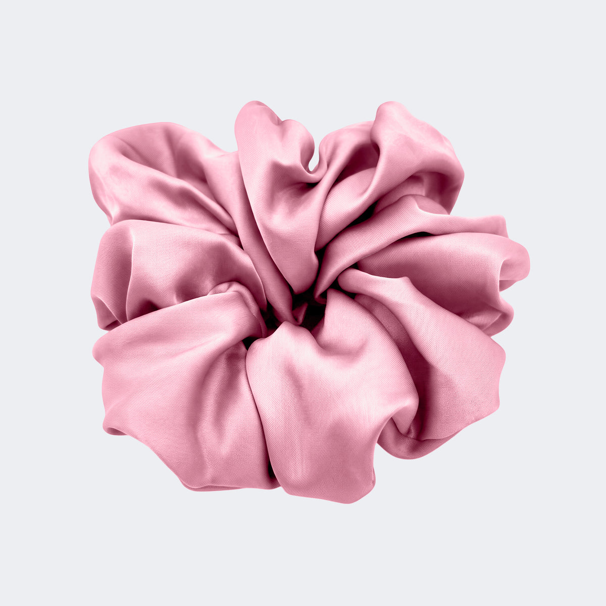 A single jumbo satin hair scrunchie in Tea Rose pink centered on a light gray background.