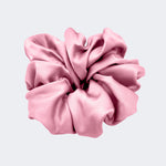 A single jumbo satin hair scrunchie in Tea Rose pink centered on a light gray background.