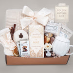 Gift basket with tea, candles, and other items on a gray background