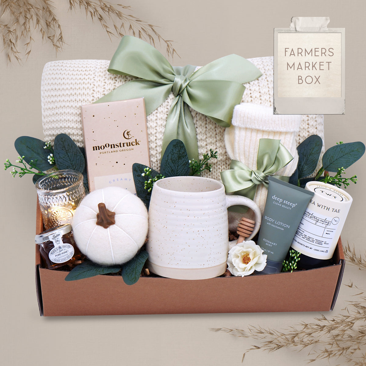 Farmers Market blanket gift box with a mug, candle, and other items on a gray background
