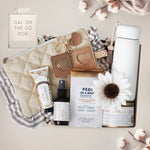 Collection of beauty and lifestyle products including a pouch, bottle, and cream on a neutral background.