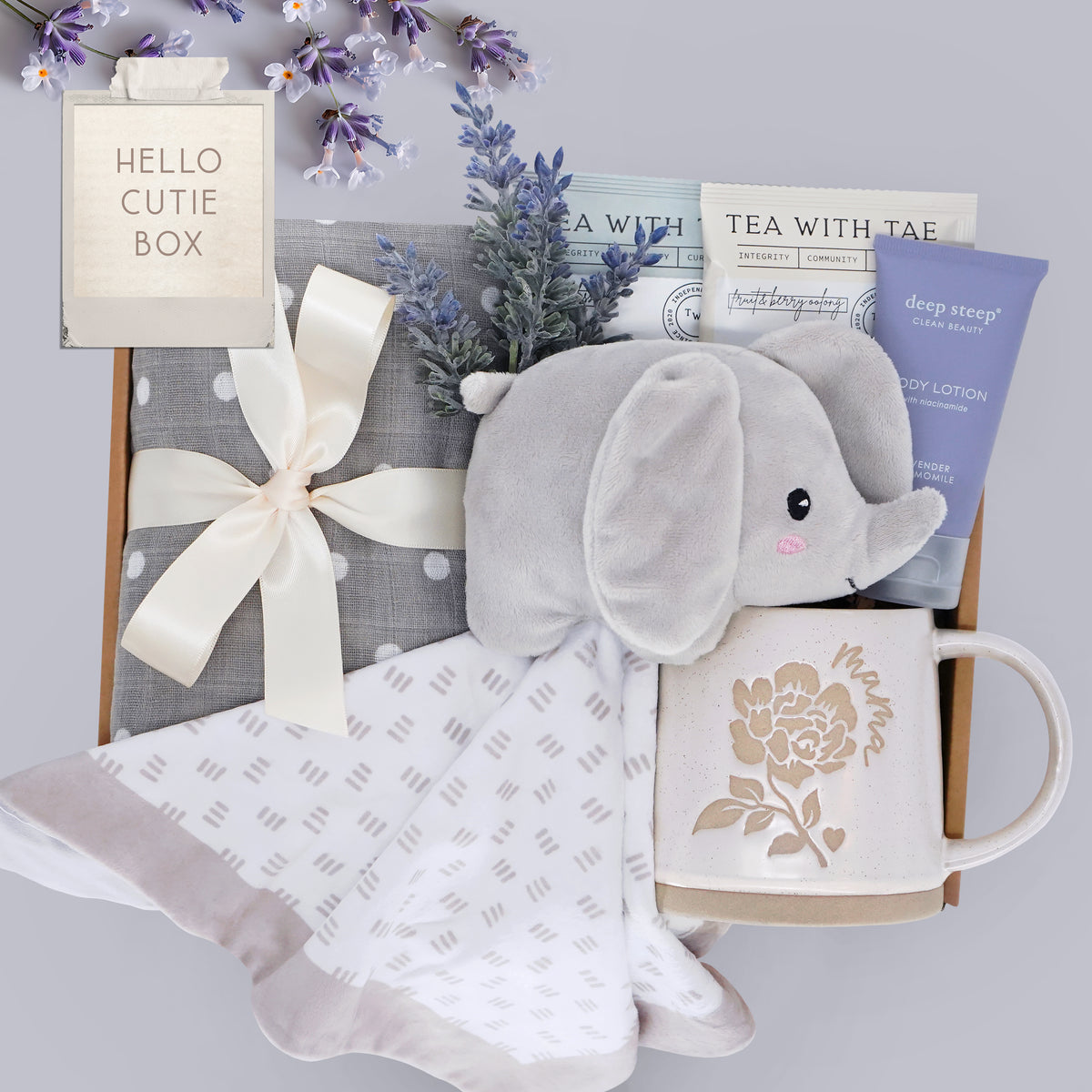 Wildflower Pop Hello Cutie New Mama box comes with grey and white polka dot swaddle, Elephant Snuggie blanket, 2 tea bags, lavender body lotion, and choice of mug