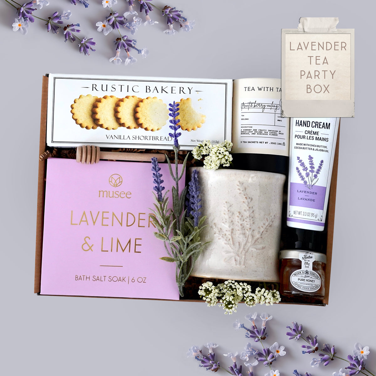 Wildflower Pop Lavender Tea Party Mug Box comes with Lavender mug, lavender and lime bath salts, vanilla shortbread cookies, tea with tae tea tube, hand cream, and mini honey and dipper