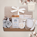 Oatmeal and Honey gift box with honeycomb blanket, tea sampler, pedi kit, grey cozy boot socks, mini honey and dipper, hand cream, and Wildflower Pop exclusive Farmhouse mug