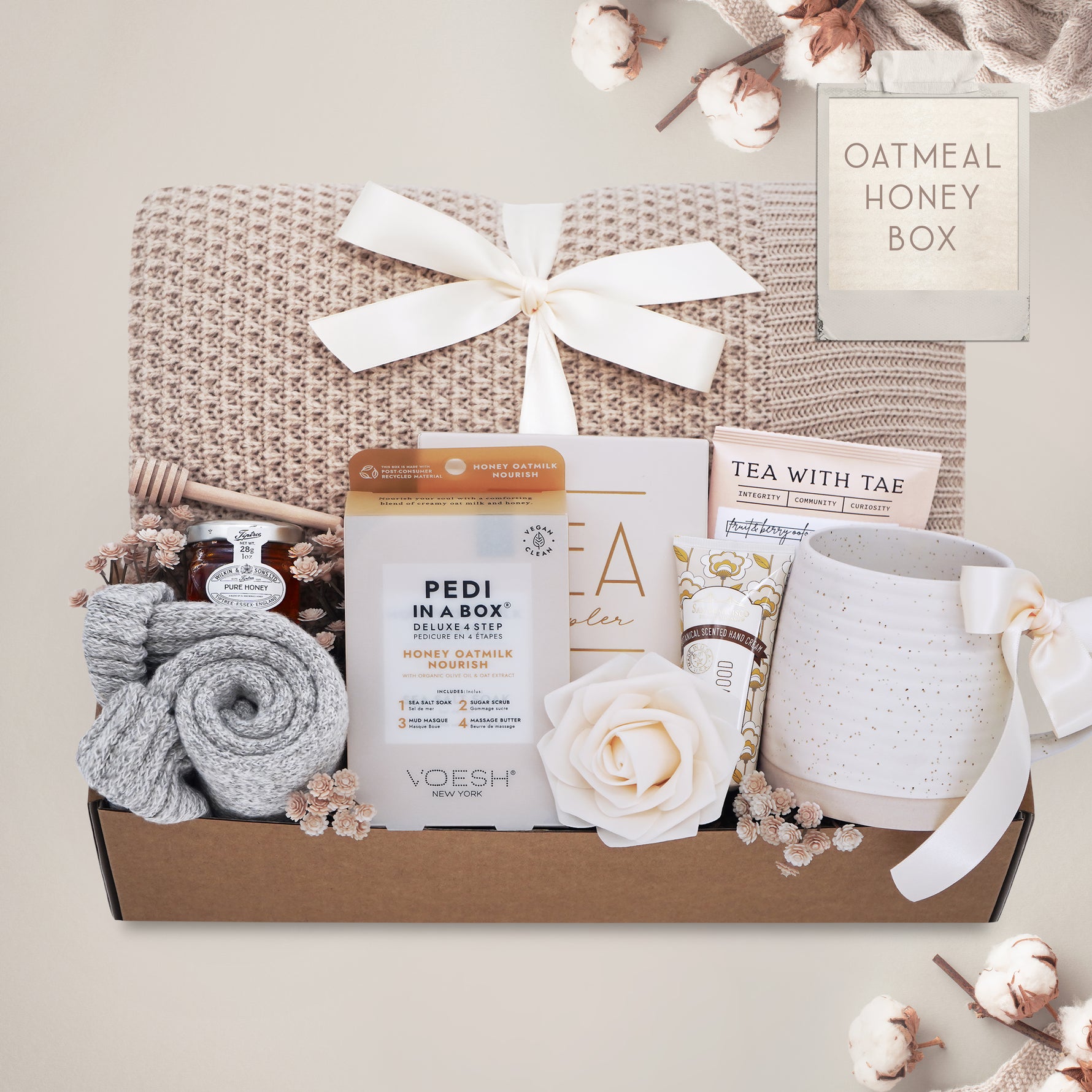 Oatmeal and Honey gift box with honeycomb blanket, tea sampler, pedi kit, grey cozy boot socks, mini honey and dipper, hand cream, and Wildflower Pop exclusive Farmhouse mug