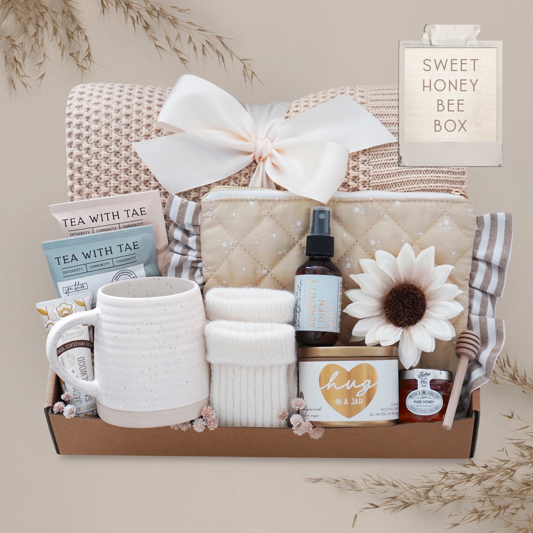 Sweet Honeybee luxury gift box featuring honeycomb knit blanket, candle, tea, mug, honey jar, socks, and self-care essentials