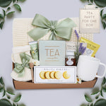 Wildflower Pop Tea Party for One comes with a cream lace knit blanket, cream knit socks, Flower Market Gardenia hand cream, Tea Sampler, Rustic Bakery shortbread cookies, ribbed white ceramic mug, mini honey and dipper