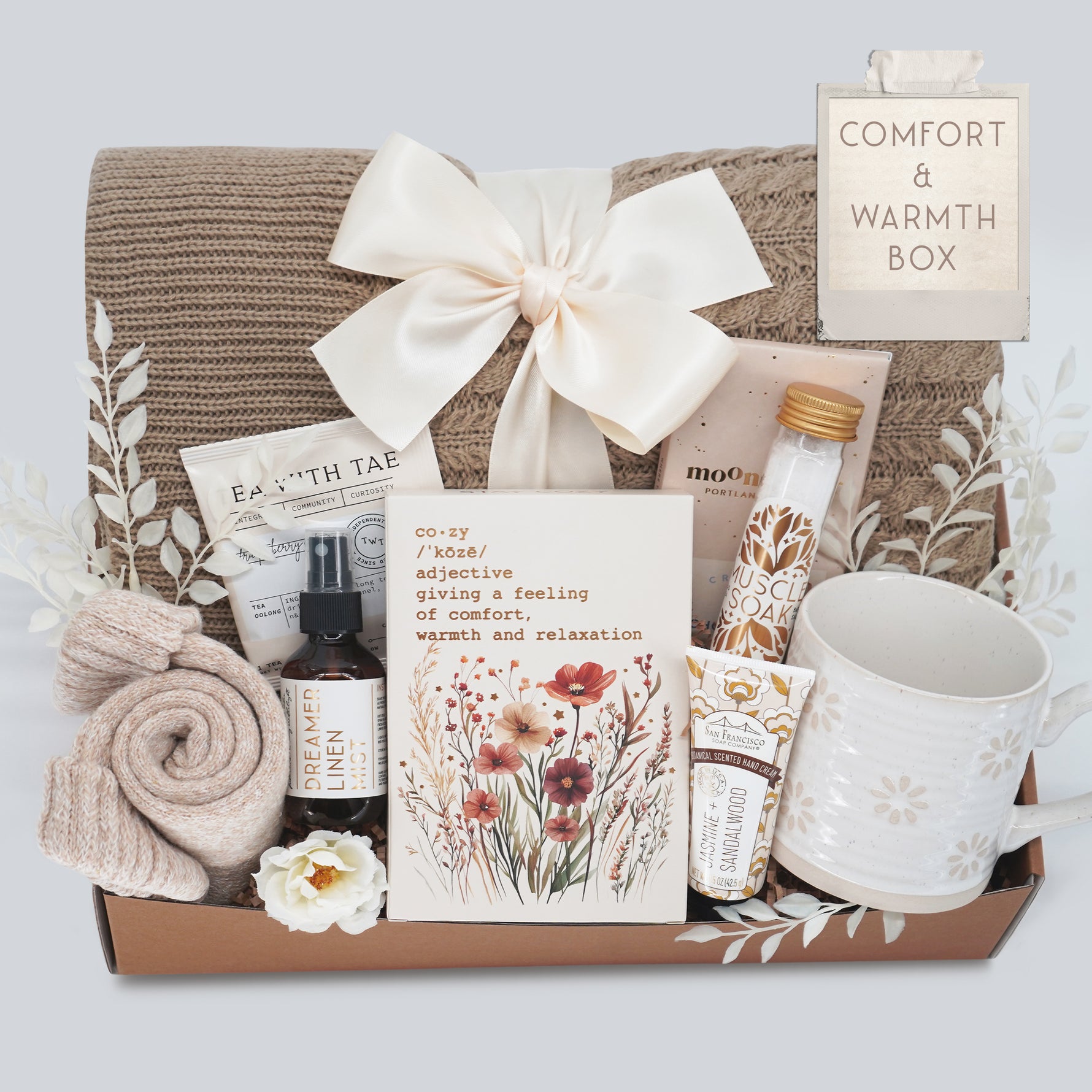 Wildflower Pop Gift box labeled 'Comfort & Warmth Box' with a blanket, mug, and various items on a light gray background.