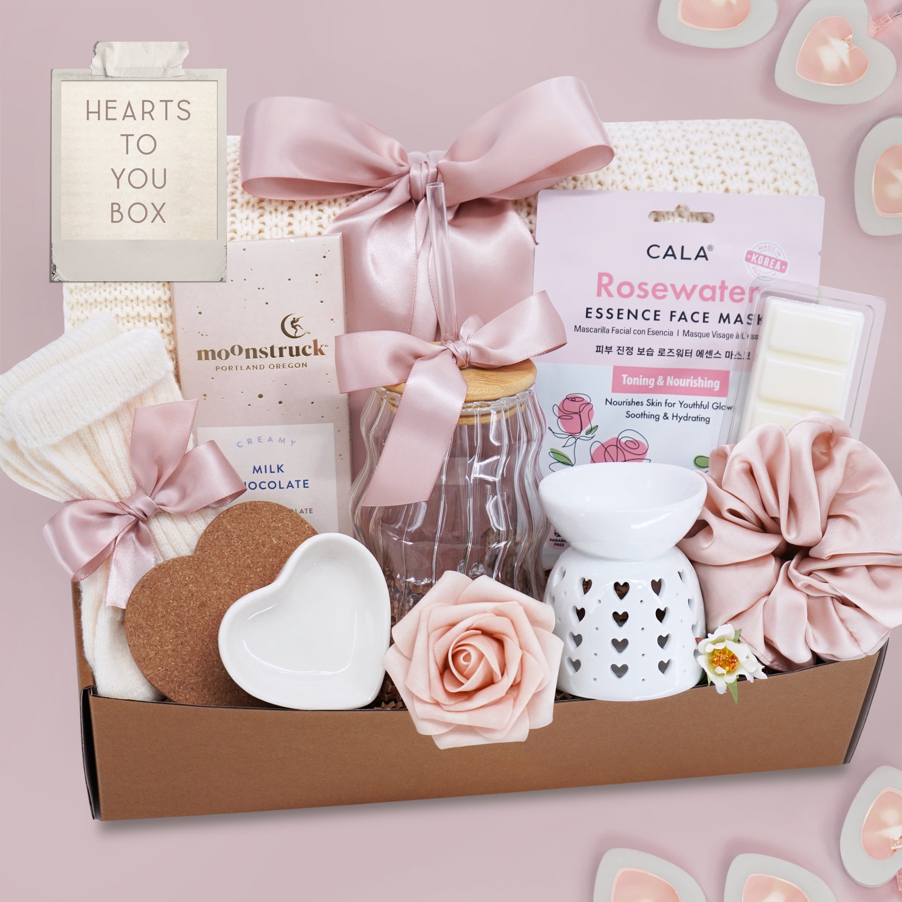 Wildflower Pop Hearts to You Valentine's  Day Gift Box with a cream lace knit blanket, Rosewater face mask, moon struck milk chocolate bar, cream knit socks, heart coaster and trinket dish, wavy glass tumbler, heart wax warmer, wax melt, and blush scrunchie 